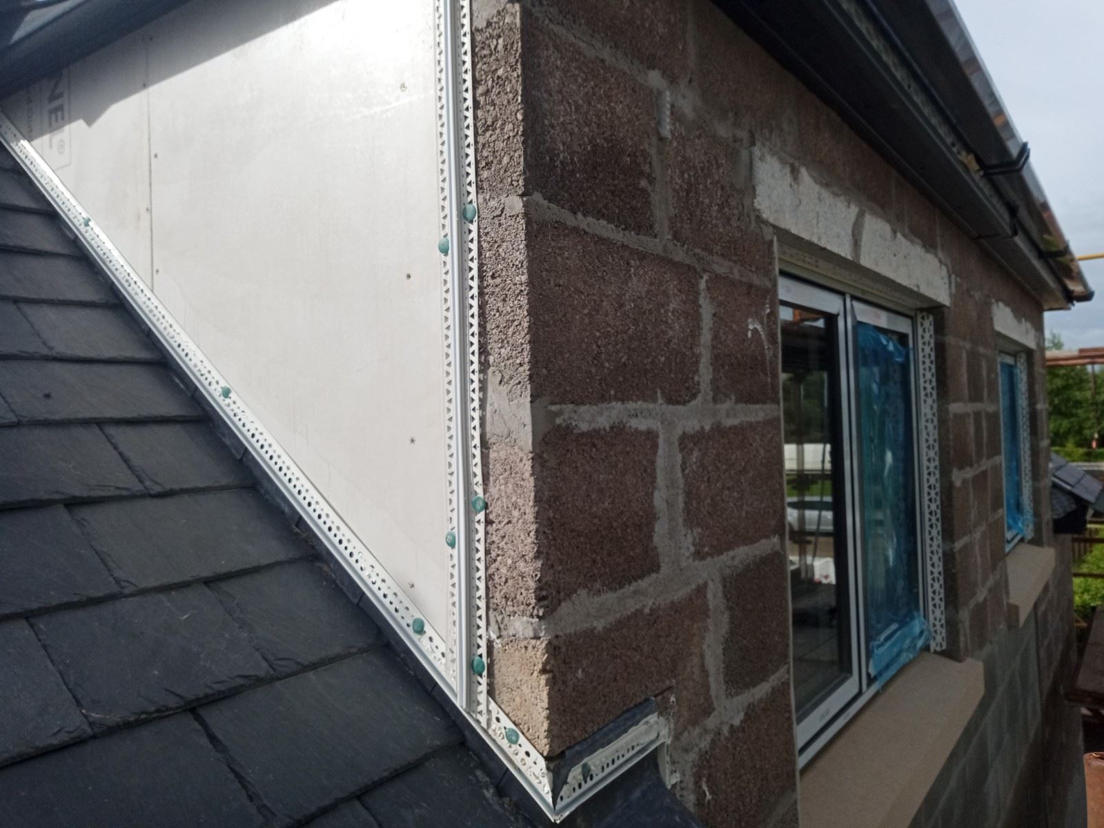 Rendering Edinburgh on corner section with blue-covered window