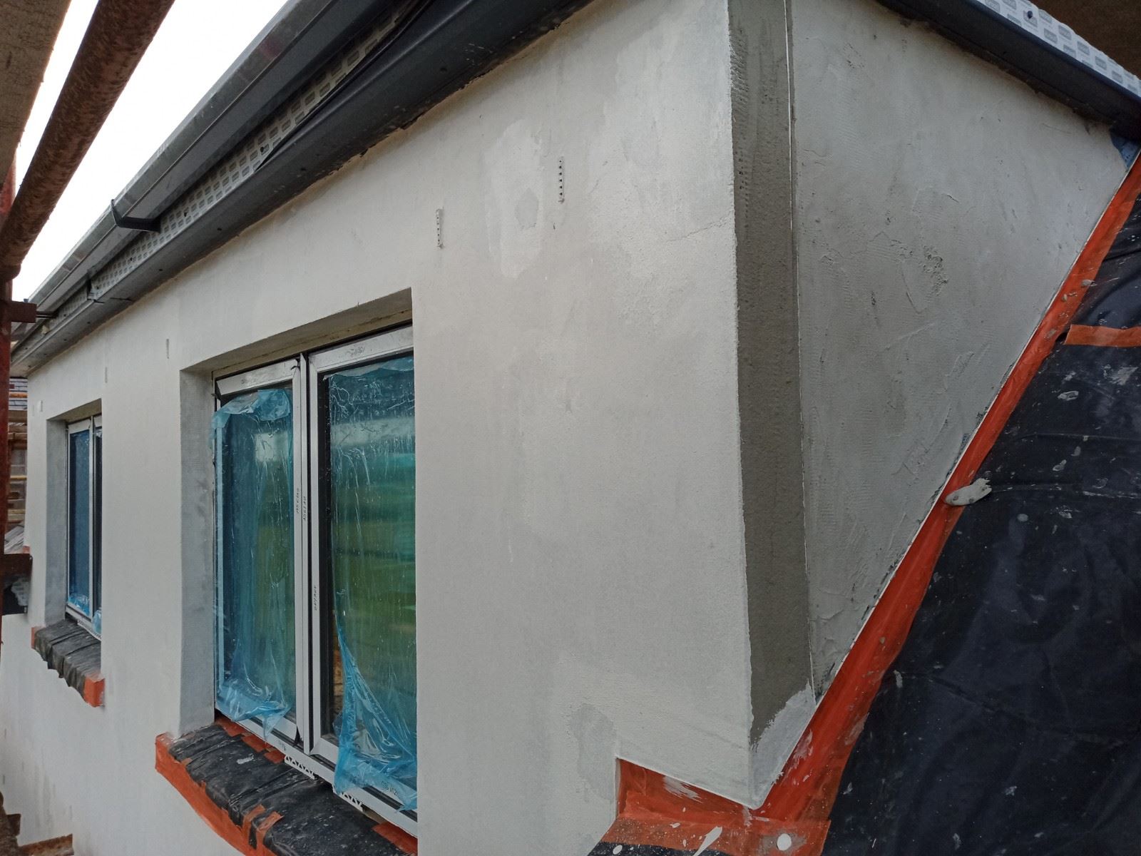 roughcasting Edinburgh on corner wall with window and fresh coat applied