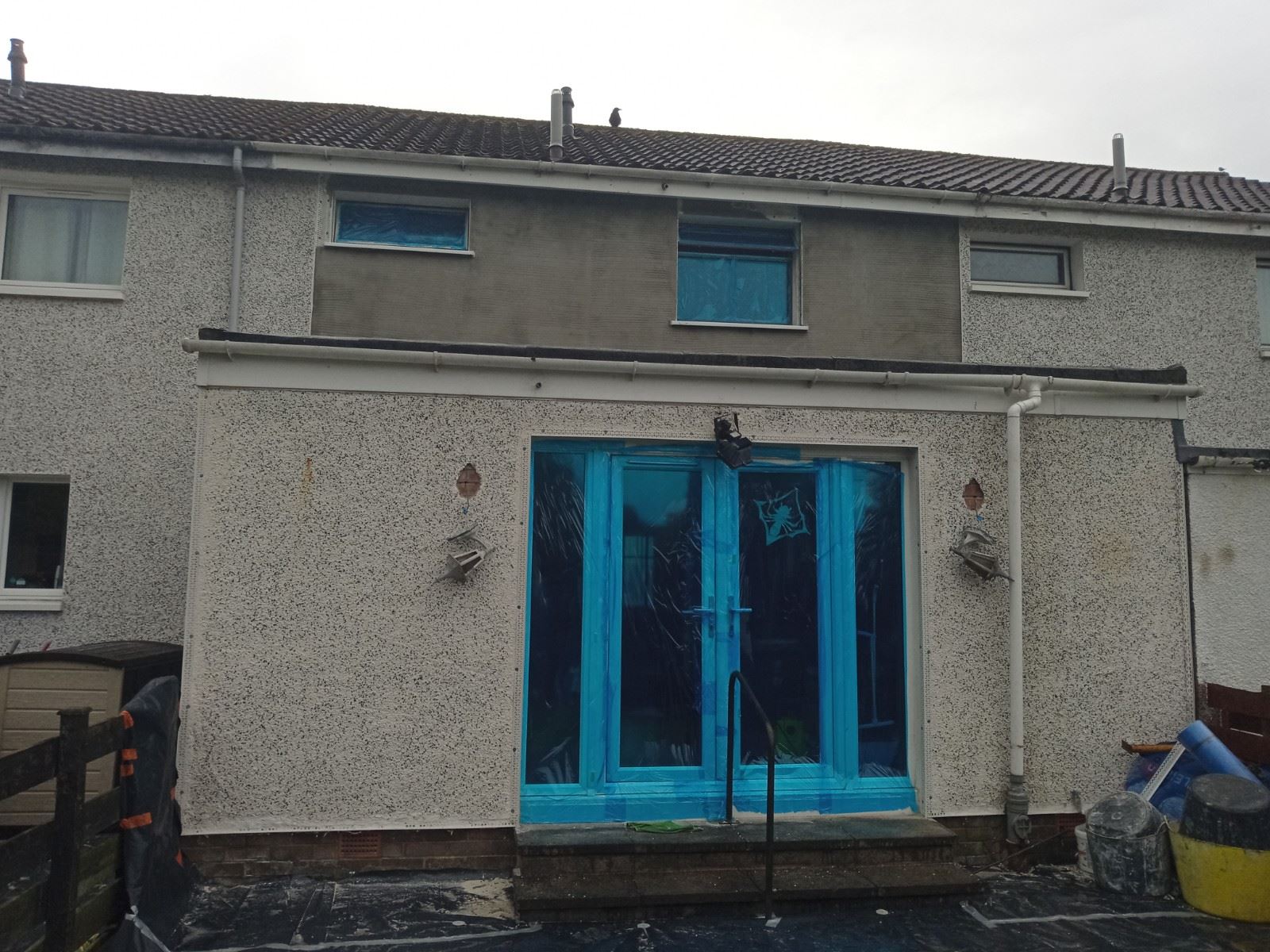 Rendering Edinburgh on rear wall with entry door under renovation