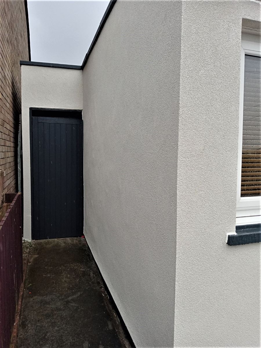 roughcast render Edinburgh on clean side path wall with dark door