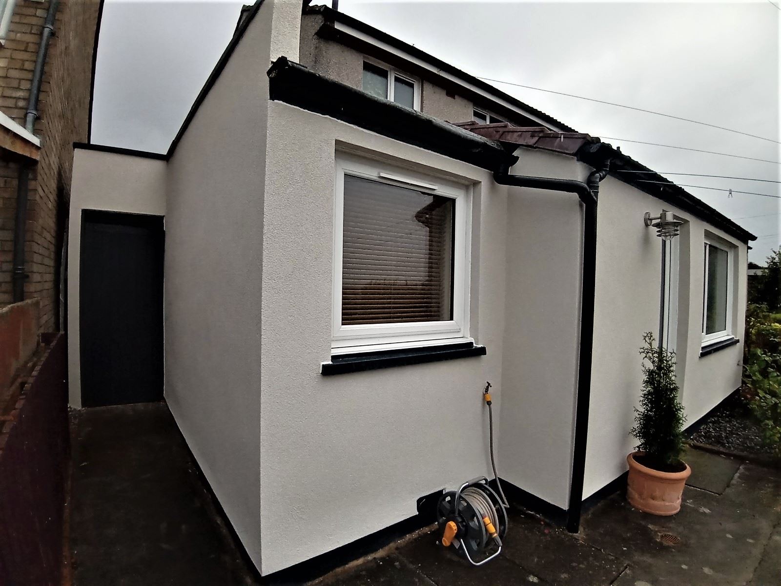 roughcasting Edinburgh on fresh white corner wall of extension