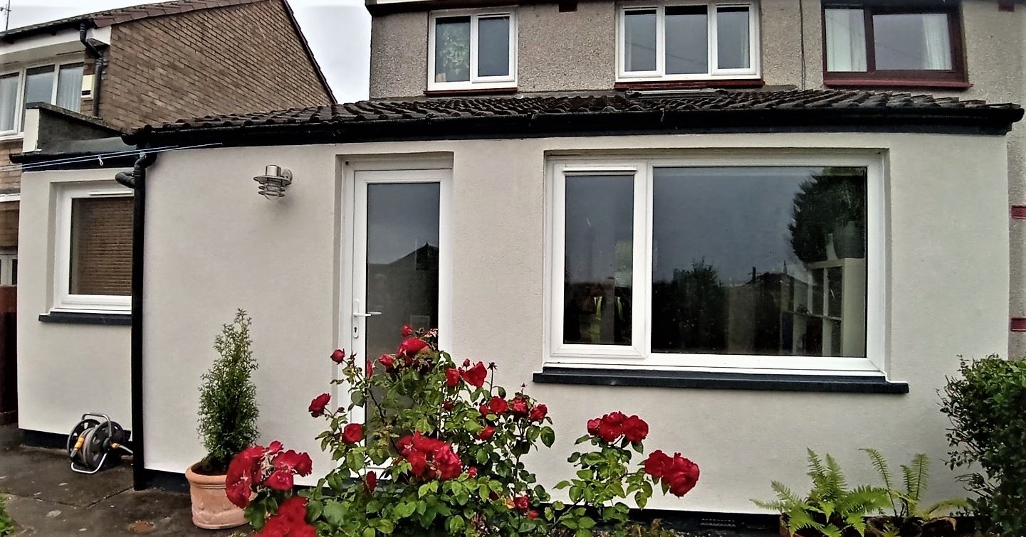 roughcast render repair completed on white house with garden roses
