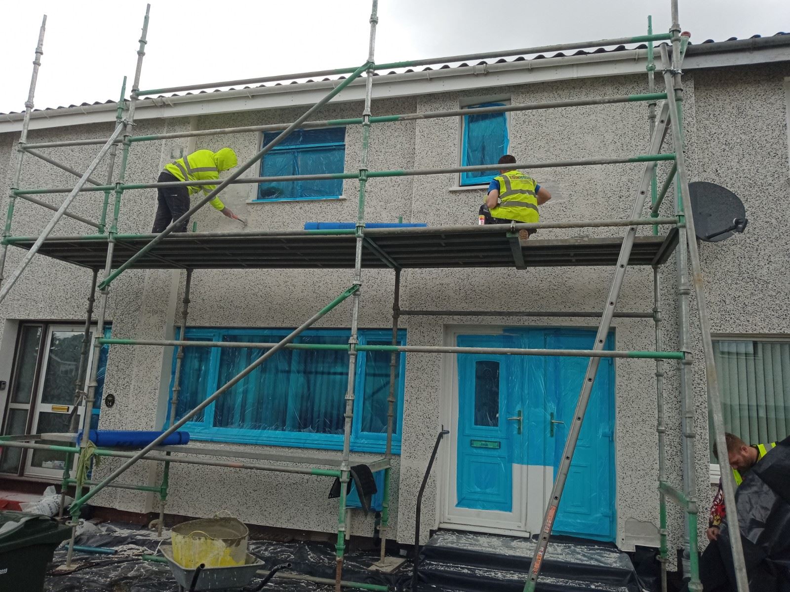 roughcast render repair on top façade under scaffolding