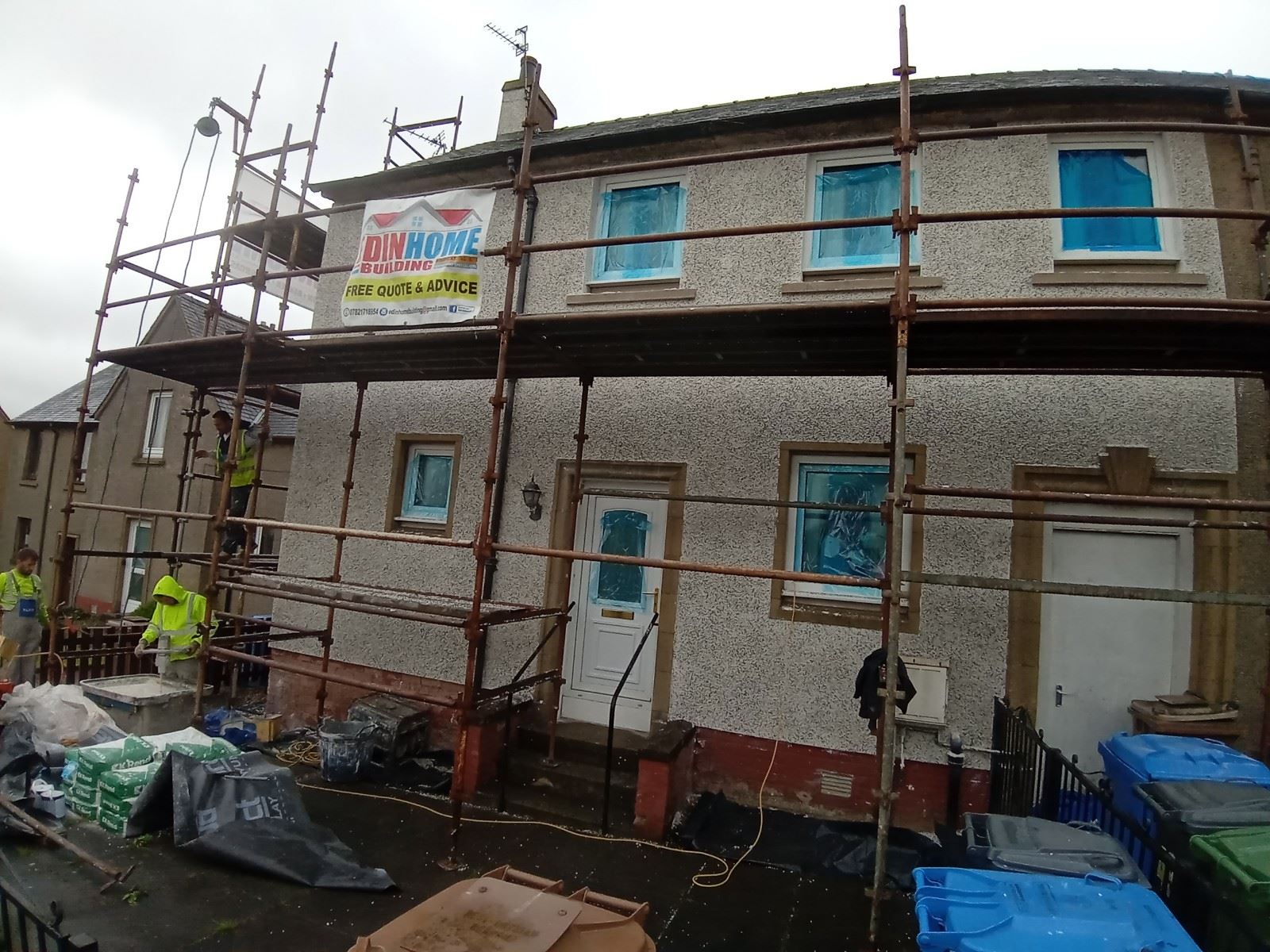 roughcasting Edinburgh on two-storey house under scaffolding with blue covers