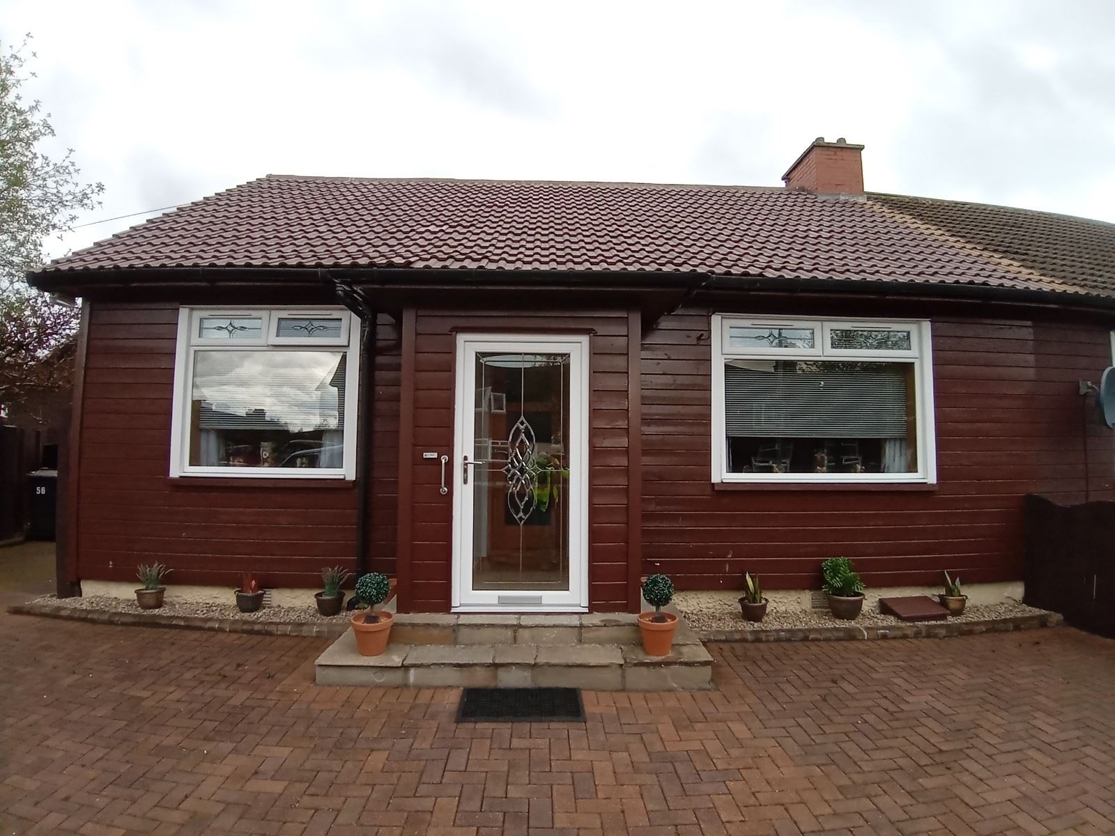roughcast render Edinburgh on home with new dark cladding panels
