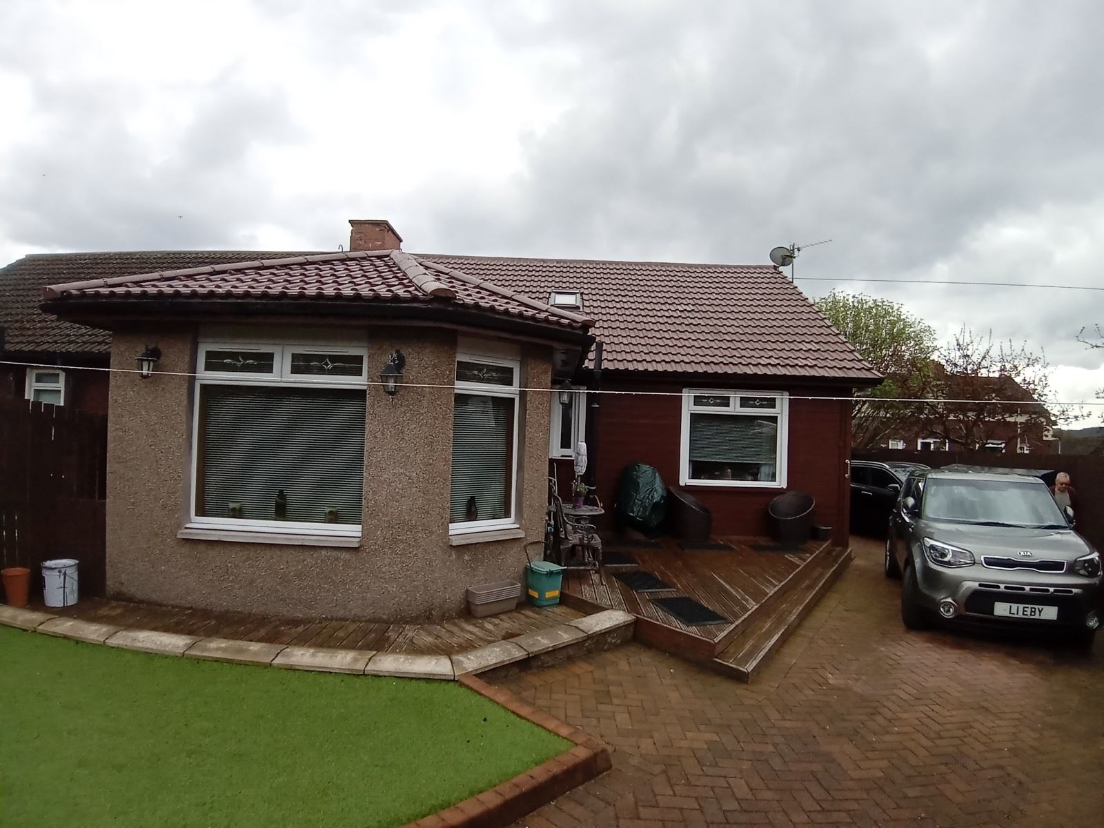 roughcasting Edinburgh on front façade of bungalow with bay window