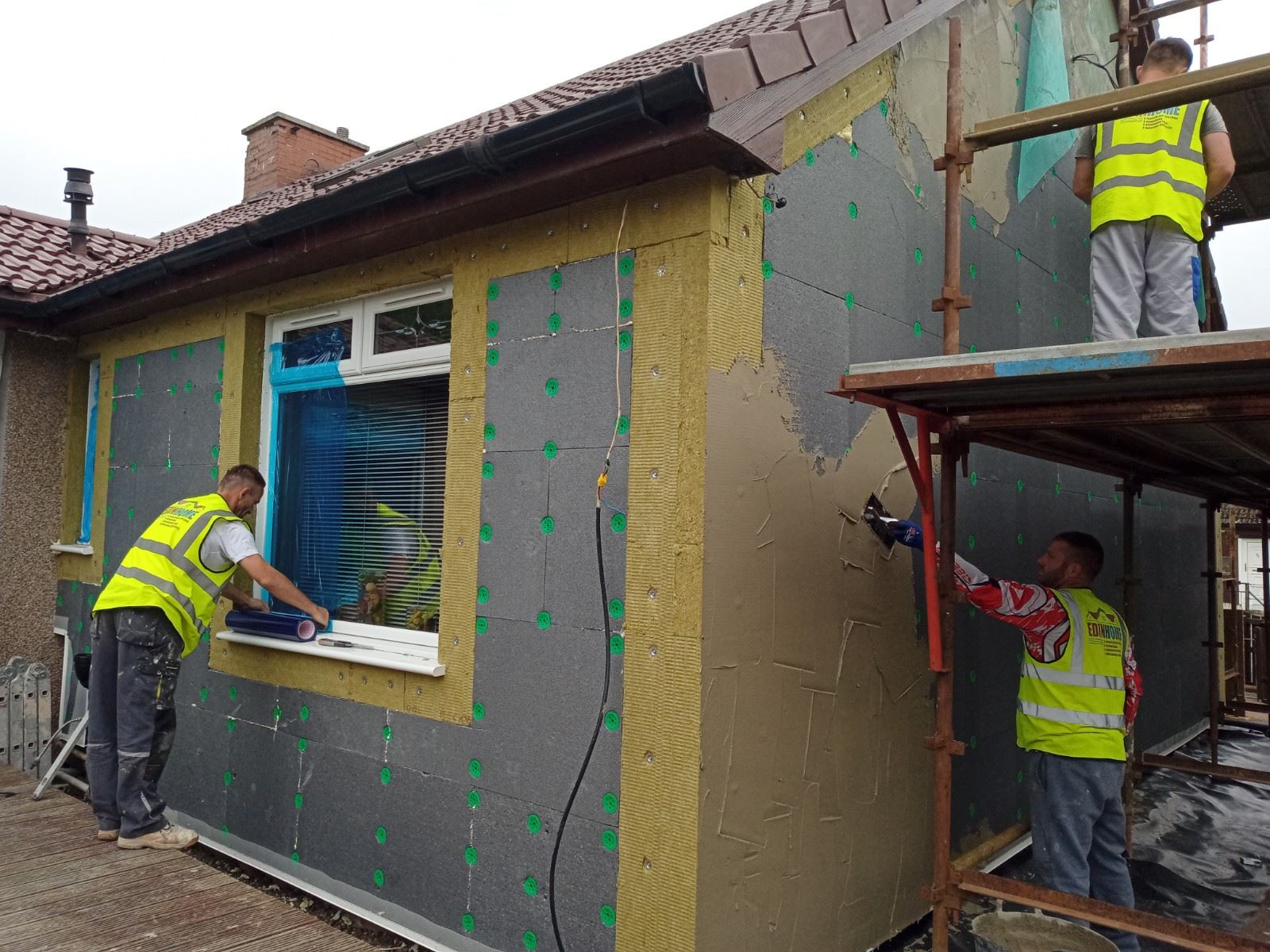 roughcasting Edinburgh with insulation boards being fitted on bungalow wall