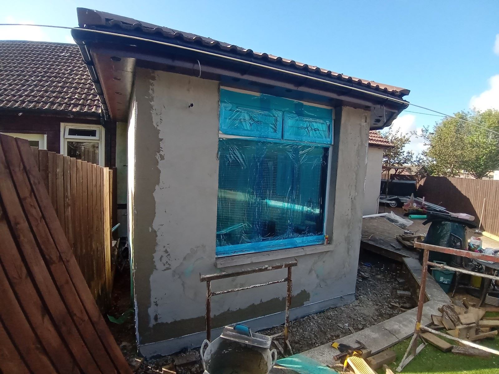 roughcast render repair on single window wall under renovation