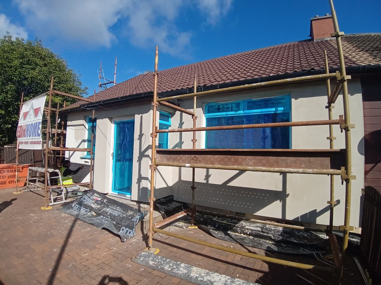 external wall insulation Edinburgh on façade under scaffold with banner