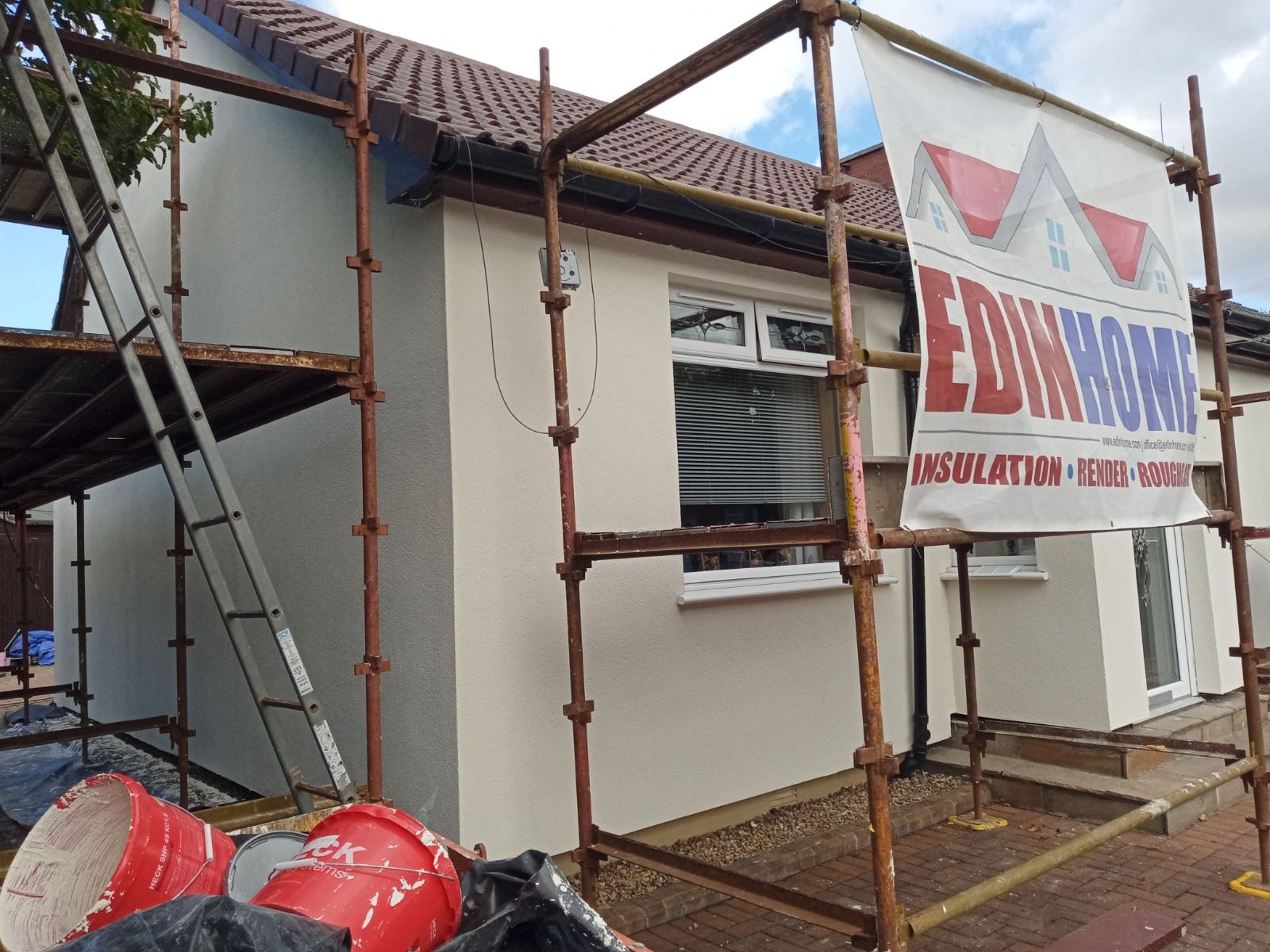 Rendering Edinburgh on bungalow wall under scaffolding