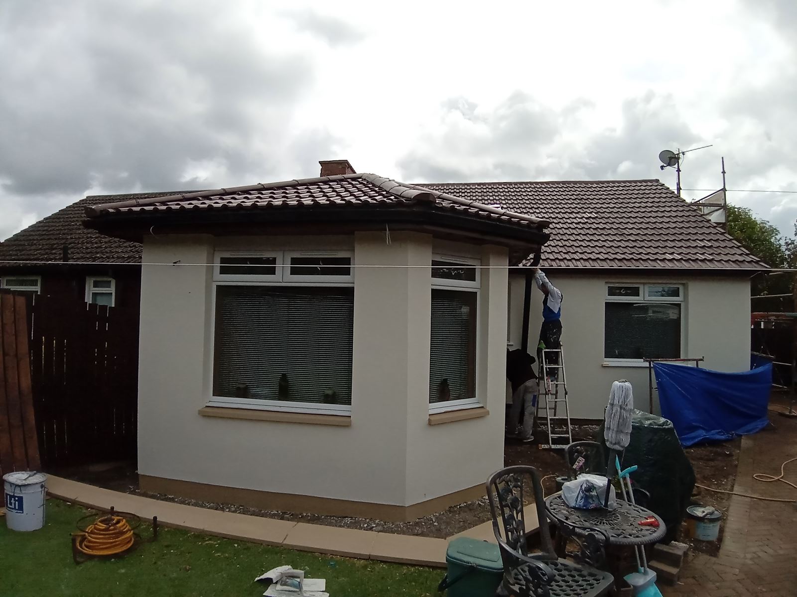 roughcast repair on side wall with modern windows