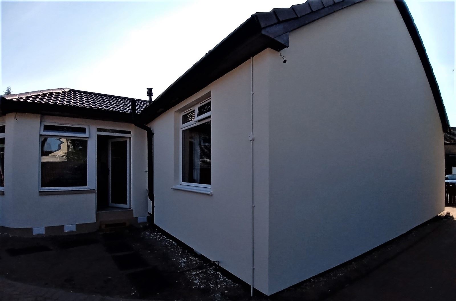 roughcast repair on corner wall of modernised bungalow