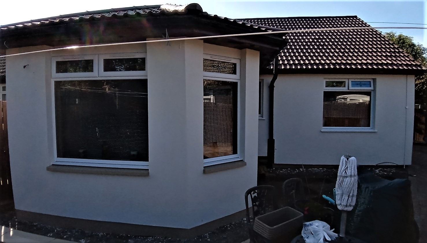roughcasting Edinburgh on white bay window extension wall
