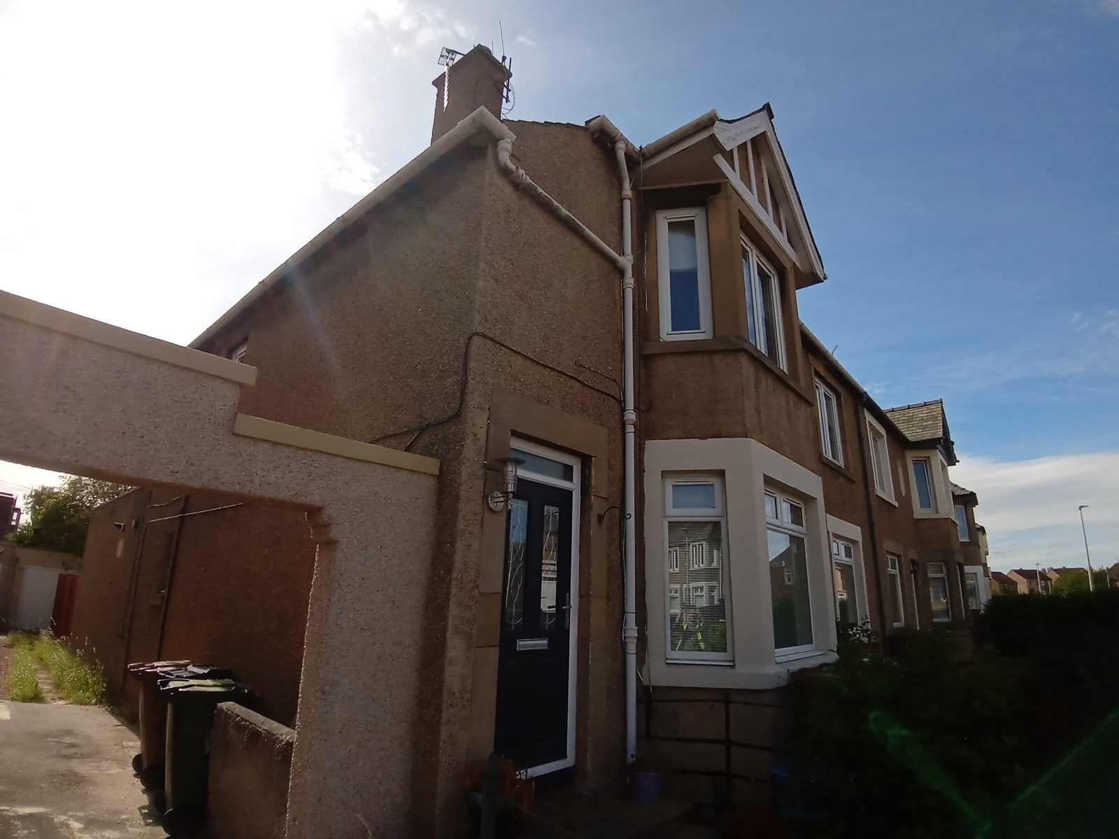 roughcaster Edinburgh working on front porch wall with dark door