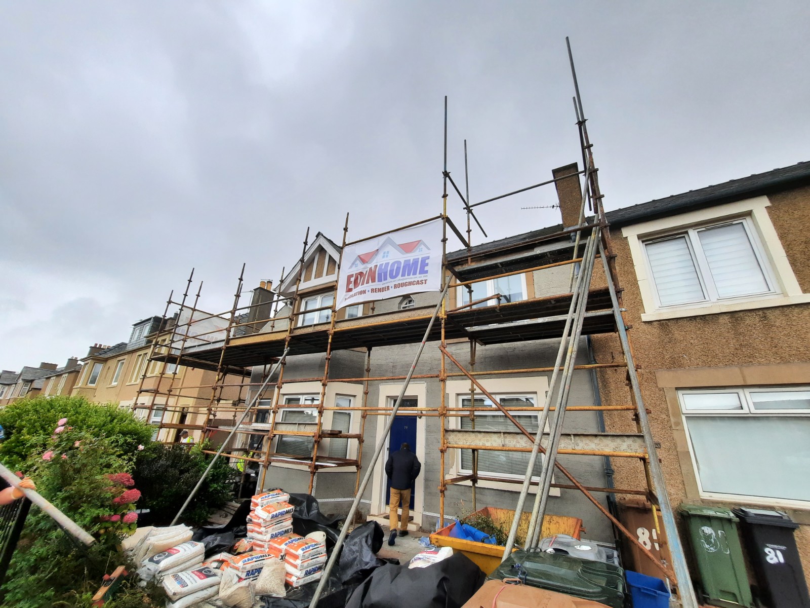 roughcast render repair in progress with scaffolding materials around