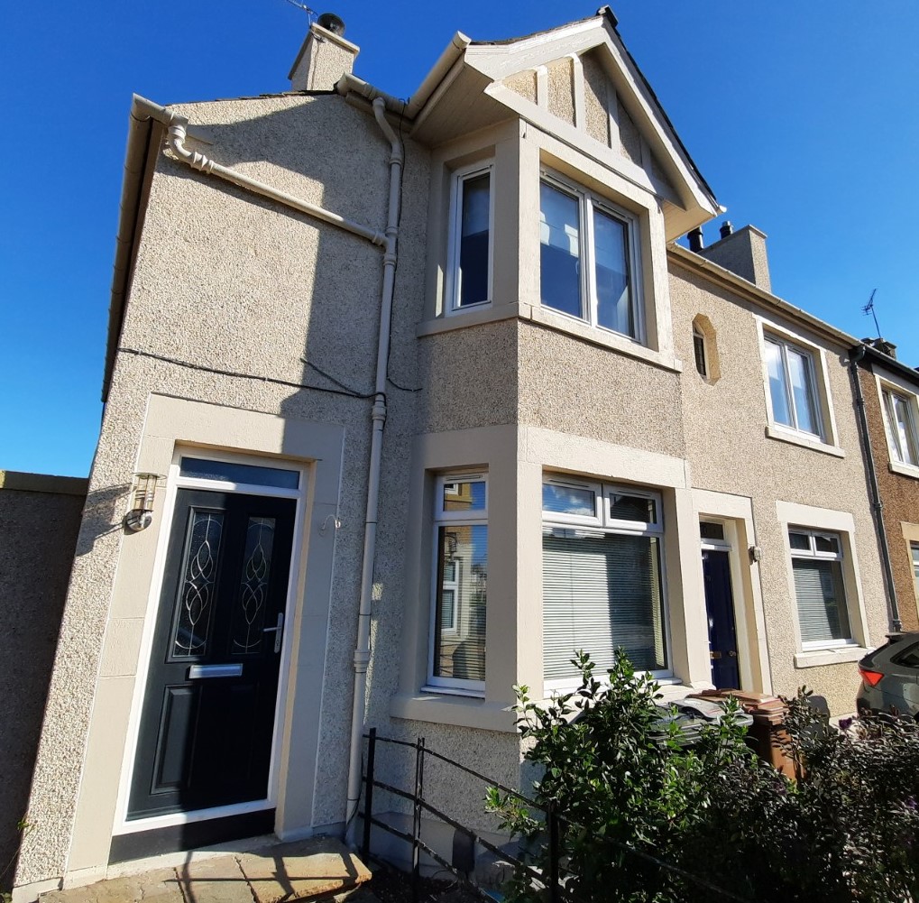 roughcast repair on front façade with angled porch extension