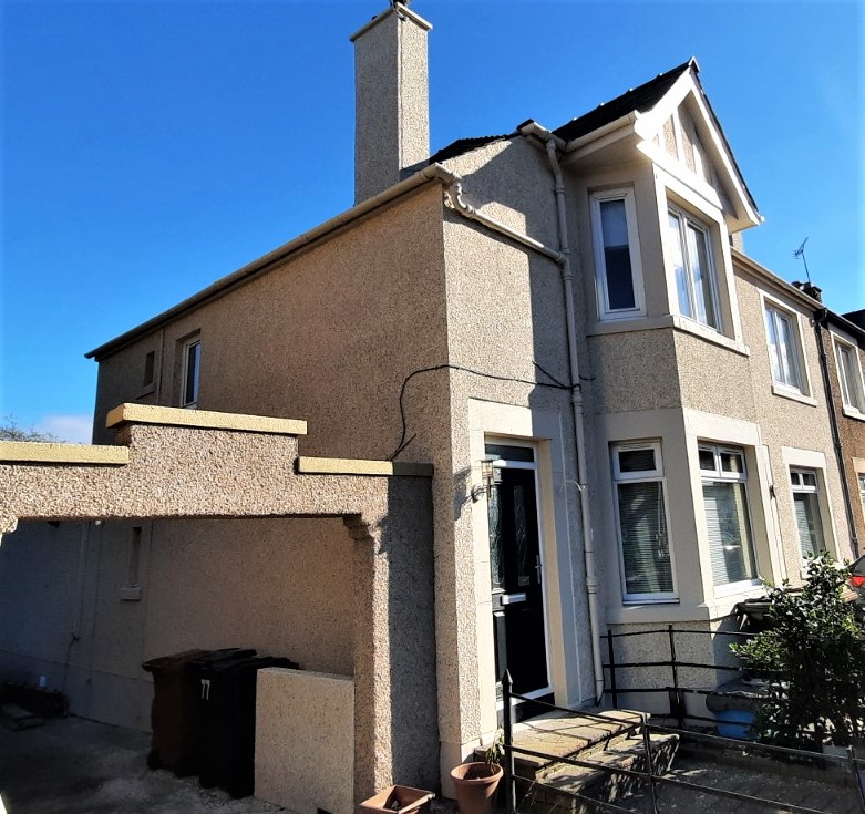 roughcast render repair on tall gable with chimney stack