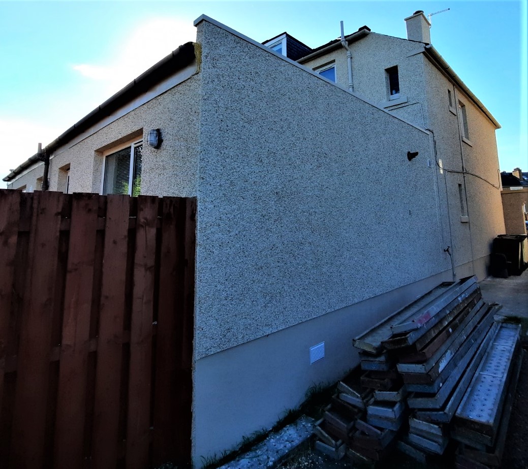 roughcast render Edinburgh on gable wall beside wooden fence