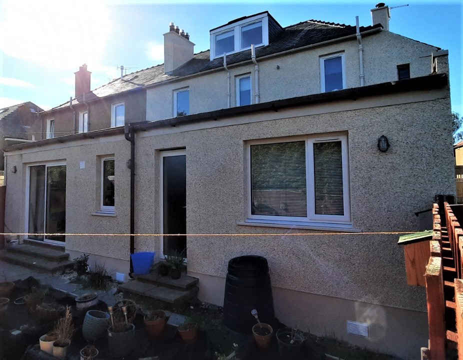 roughcasting Edinburgh on rear wall of house with ground floor window