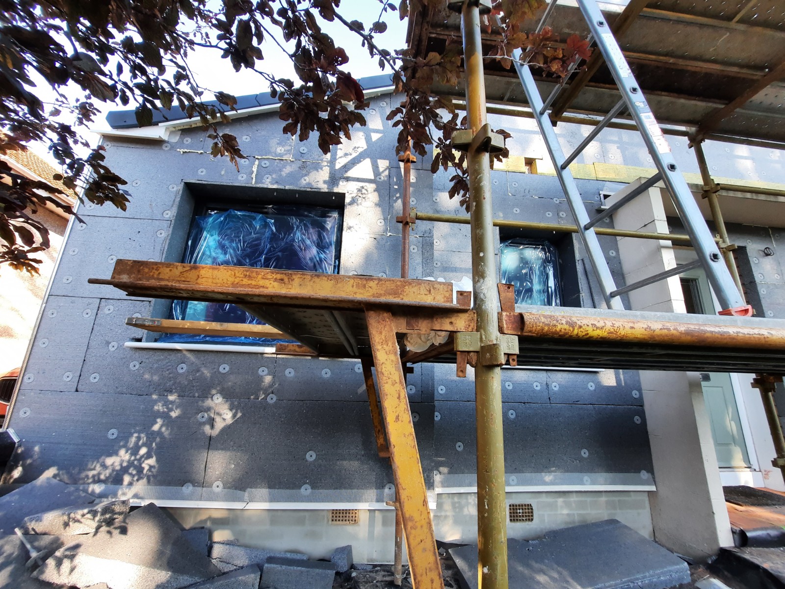 Rendering Edinburgh on scaffolded façade with blue coverings