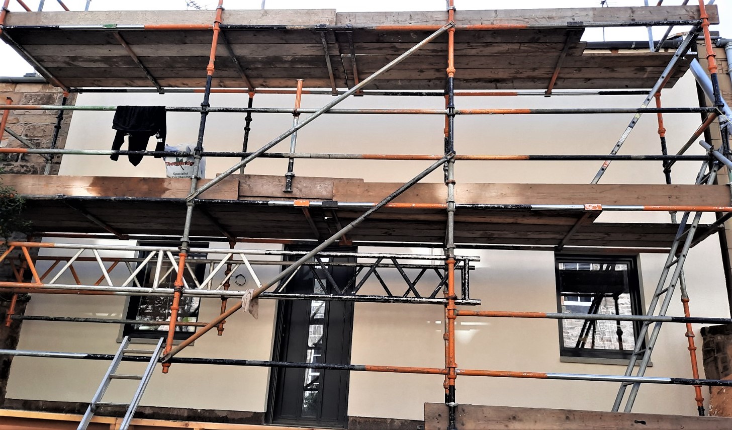 roughcasting Edinburgh on multi-storey house façade under scaffolding