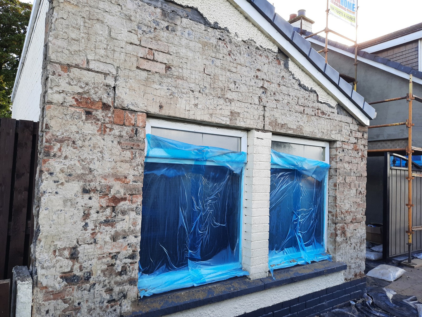 exposed brick wall prepared for roughcast repair