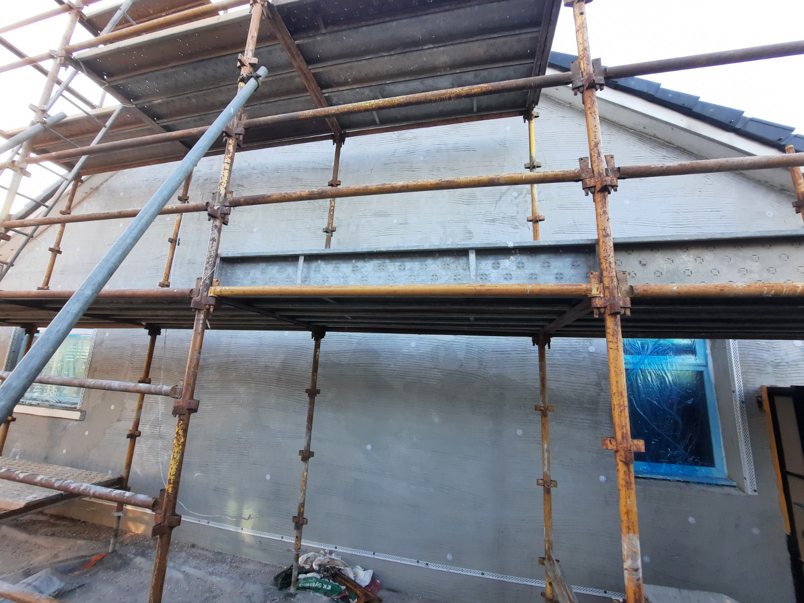 close-up scaffolding during roughcast render repair