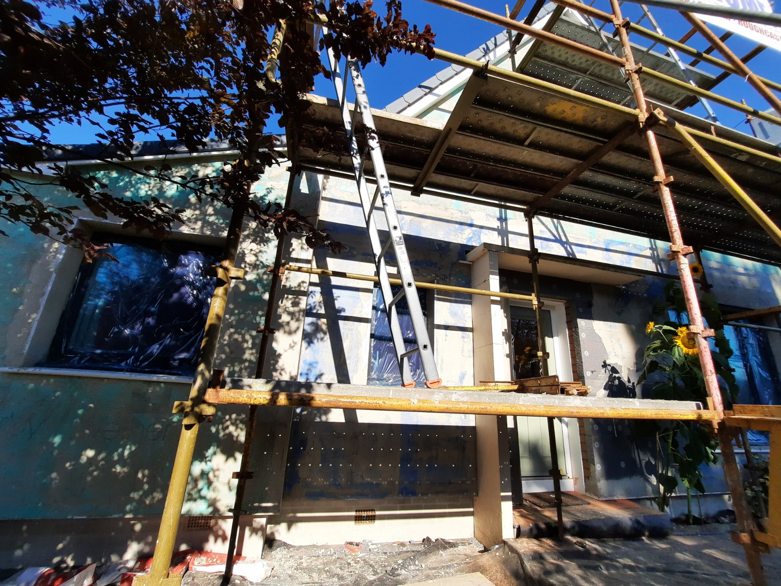roughcaster Edinburgh working on elevation with scaffold and covered windows