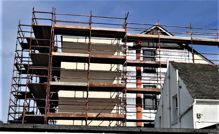 roughcasting Edinburgh on multi-storey façade under scaffolding