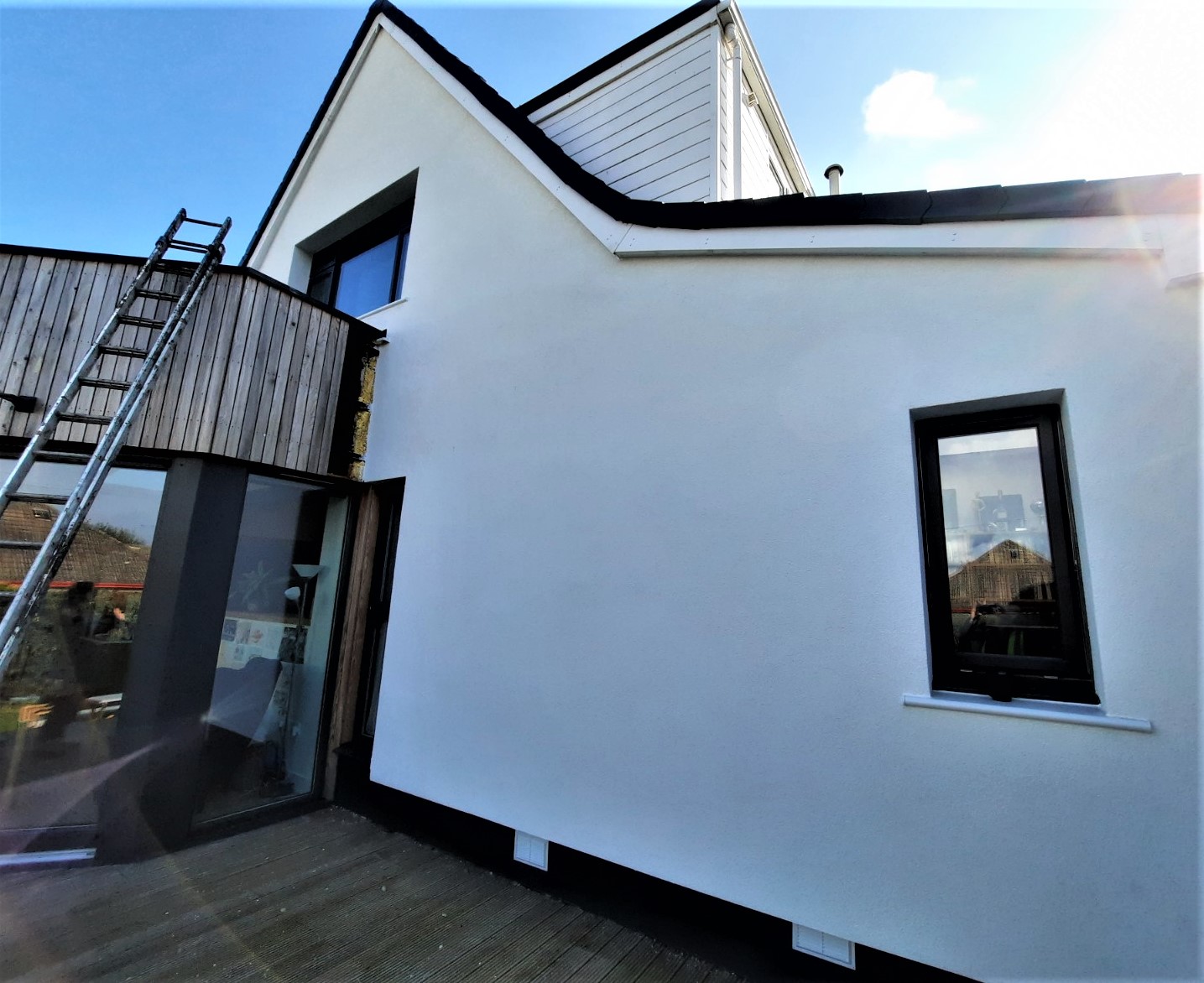 roughcast render repair on side wall in sunlight