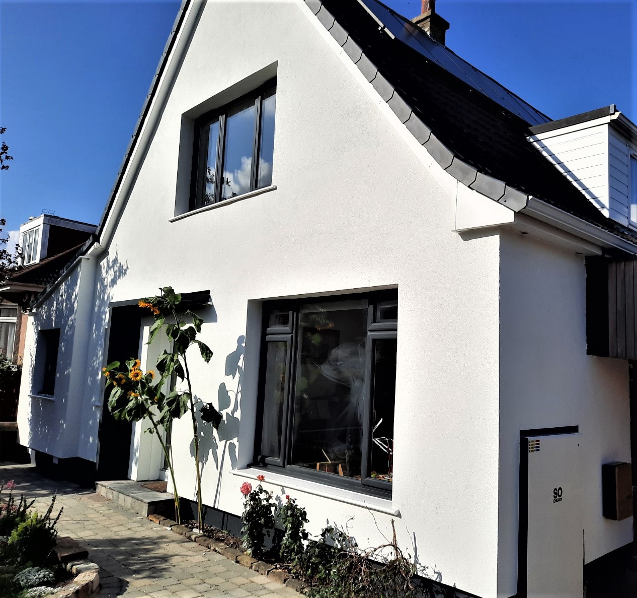 roughcast render repair on modern white house with large window