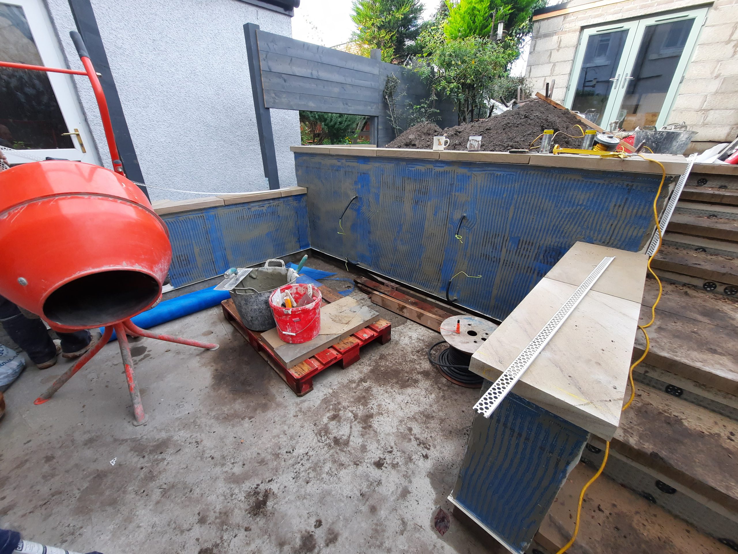 garden renovation with roughcast repair progress