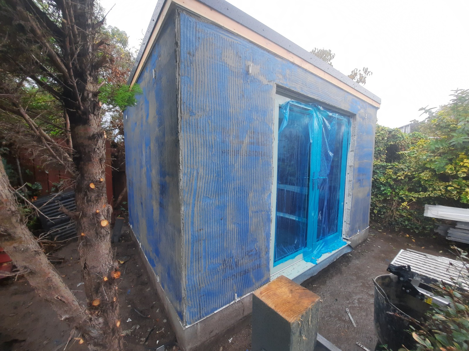 small outbuilding wrapped for external wall insulation Edinburgh