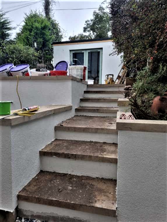 outdoor staircase with fresh roughcast repair