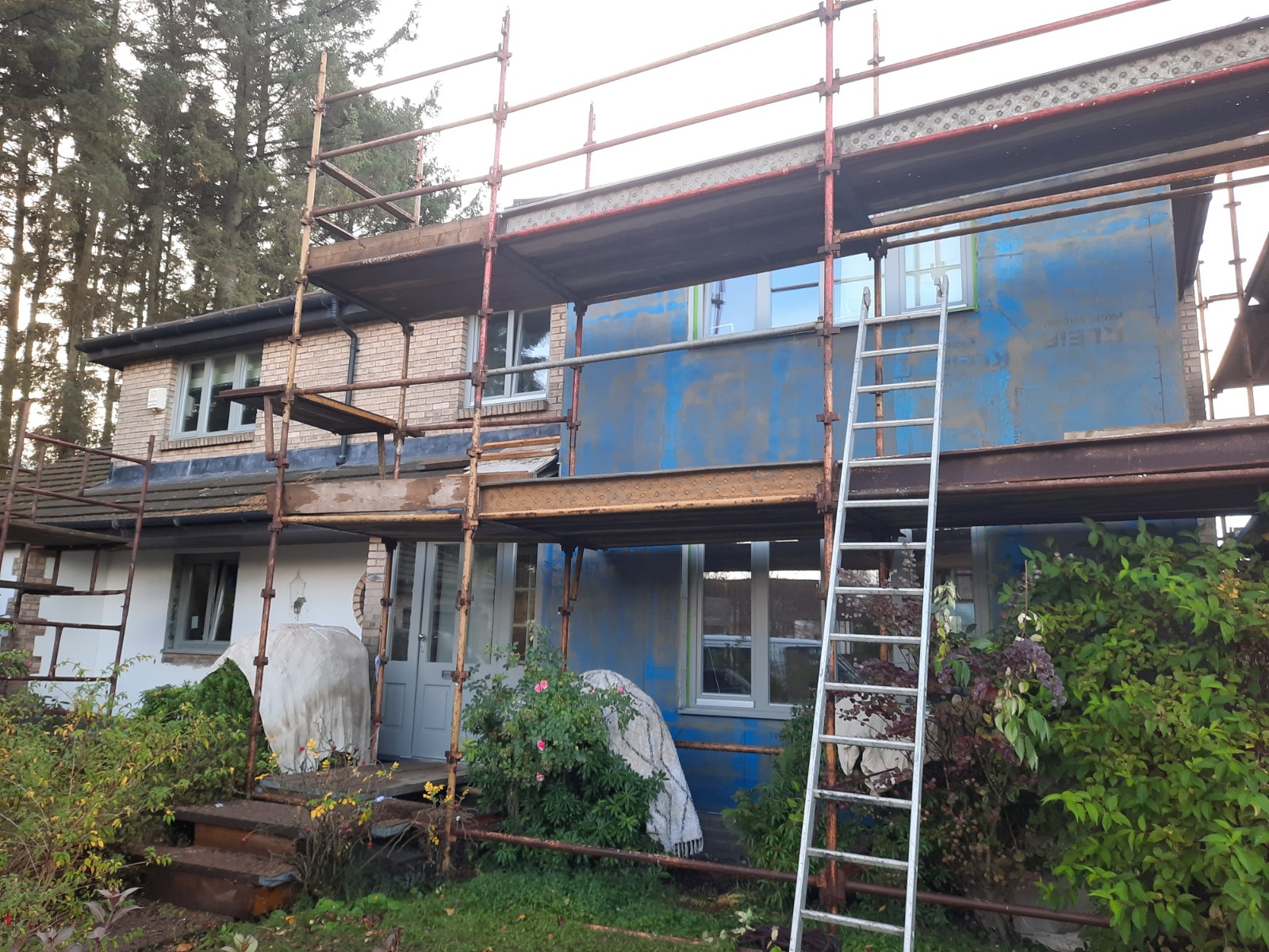 facade under scaffolding during roughcast render repair