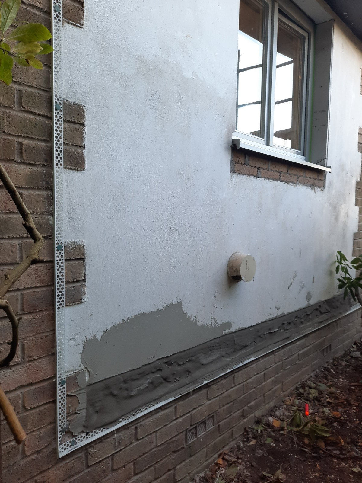 patchwork section showing roughcast repair