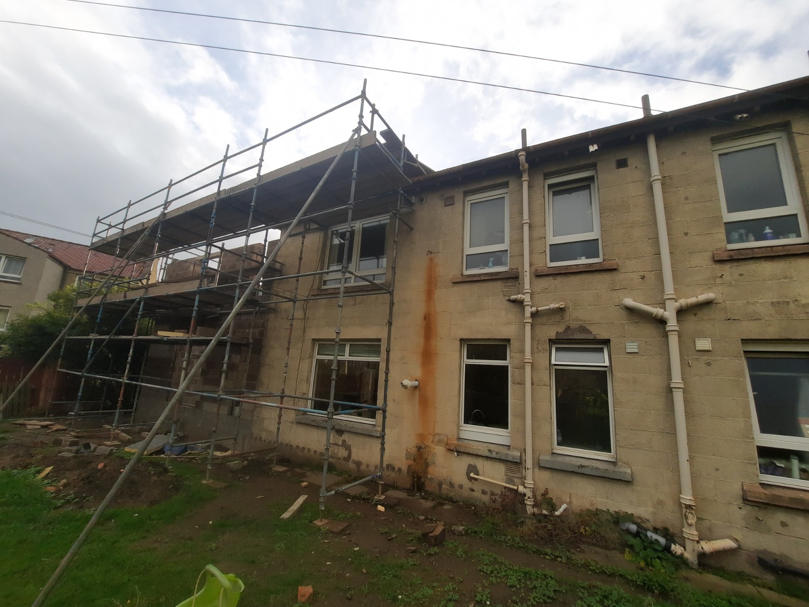 rear facade showing roughcast repair in progress