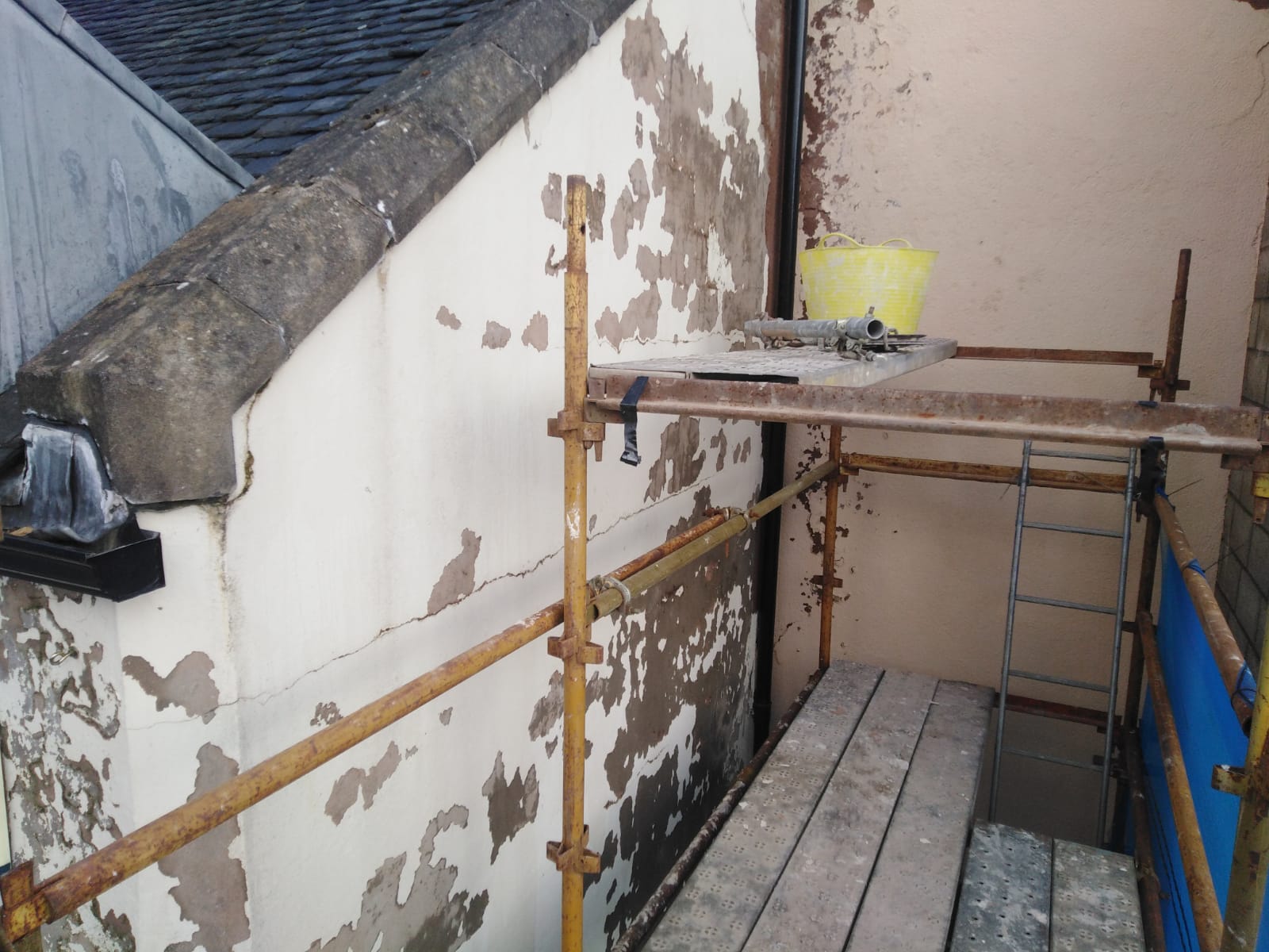 cracked wall surface needing roughcast repair