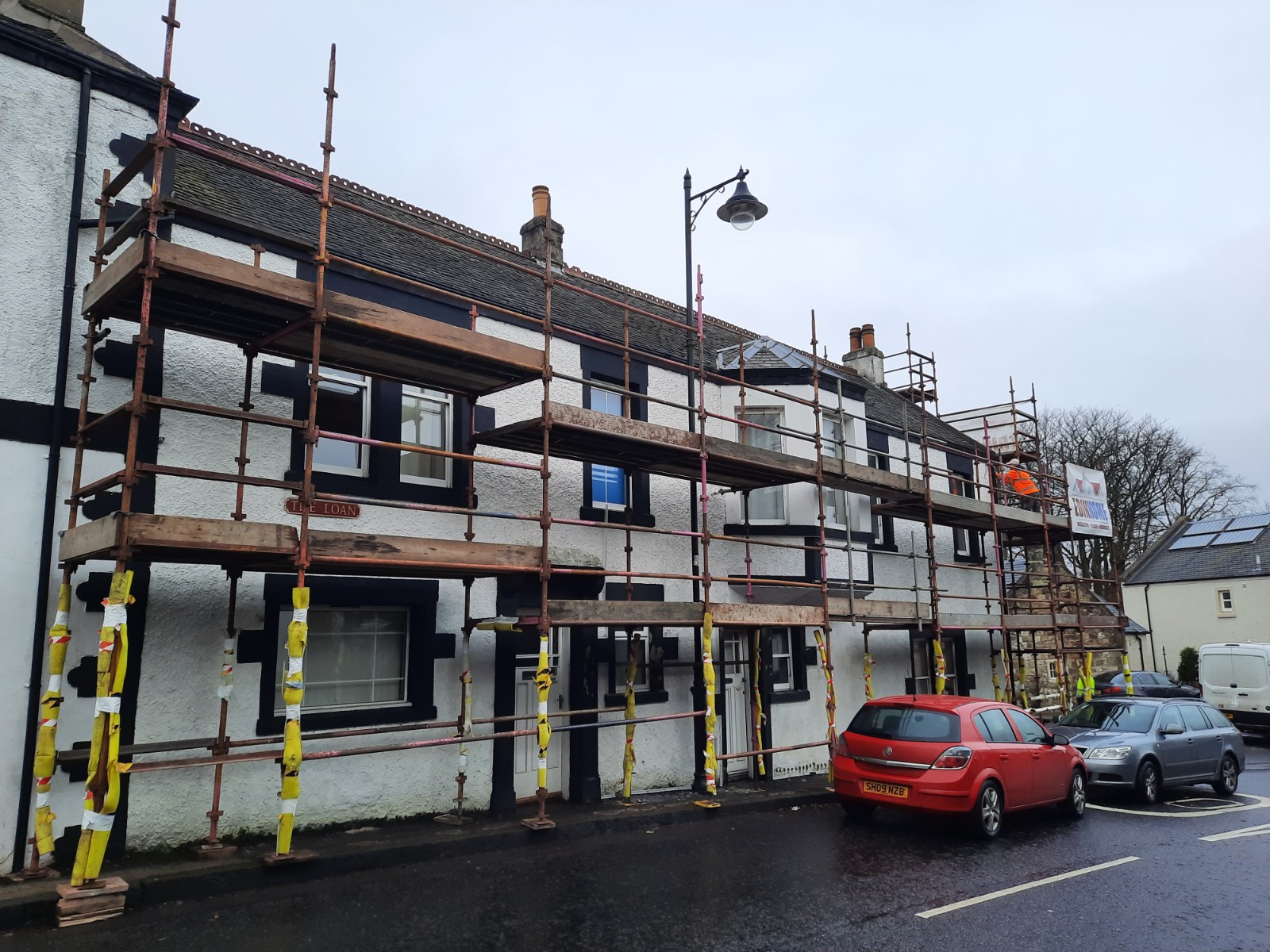 full row of homes under roughcast render repair