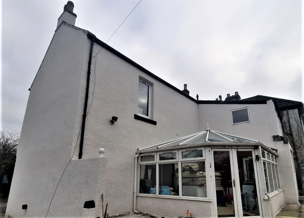 side view of home freshly finished with roughcast render Edinburgh