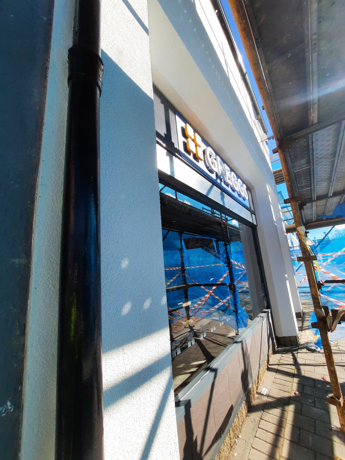 close-up shop wall with fresh roughcast render repair