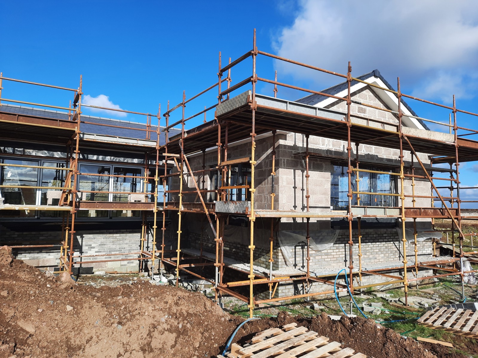 side and front under construction with roughcast render Edinburgh