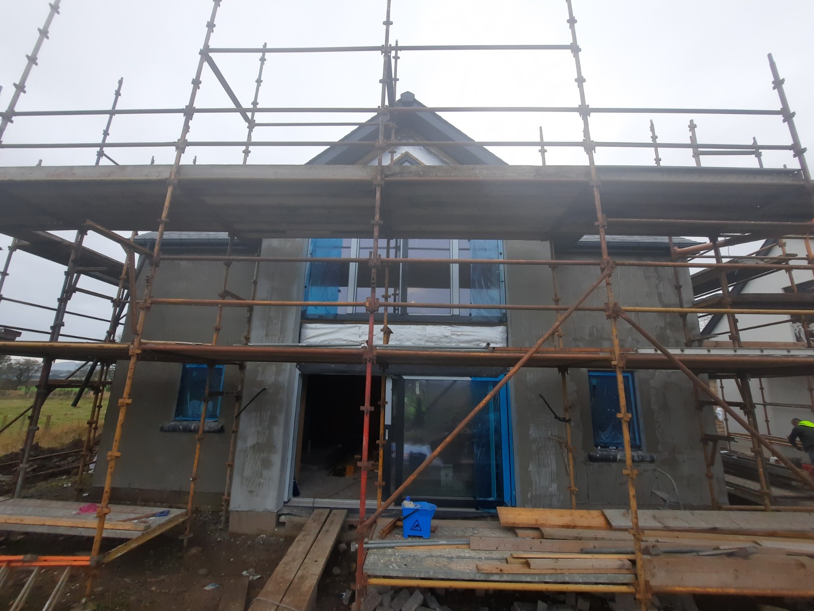 front scaffolding with fresh roughcast render repair