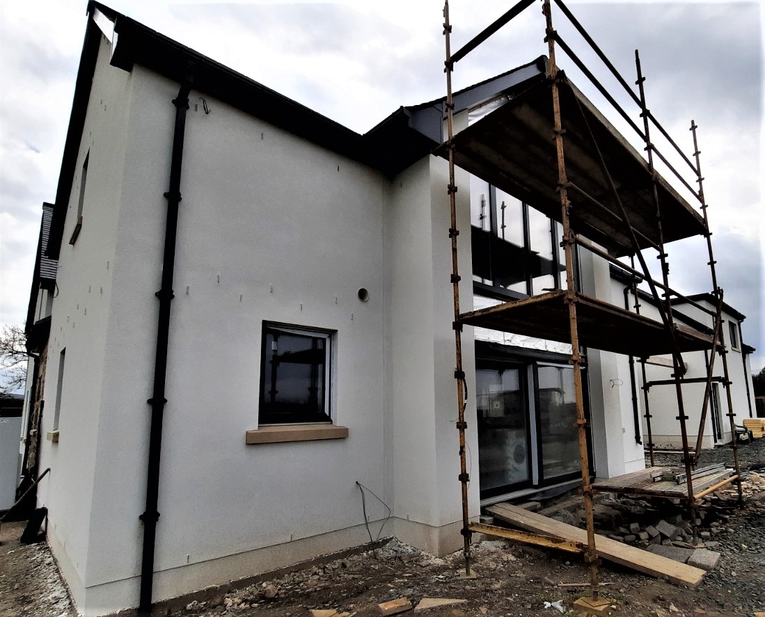 side wall view with fresh roughcast render repair