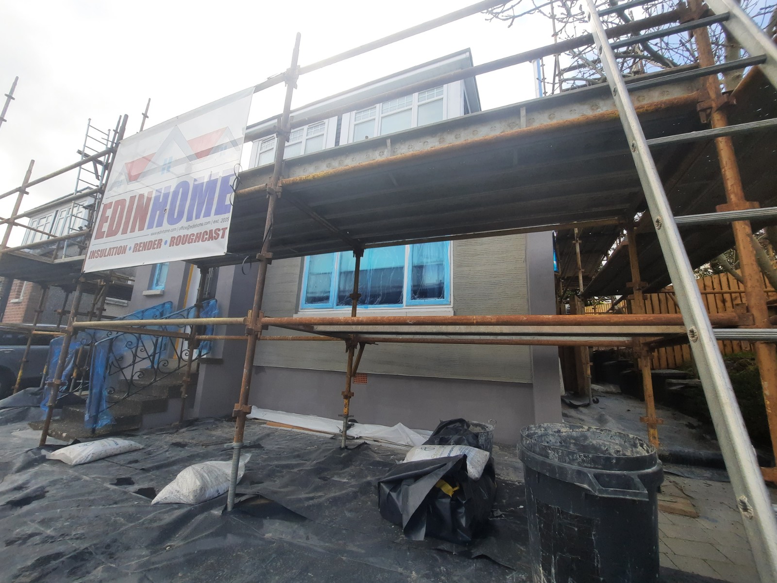 workers preparing surface for house rendering Edinburgh