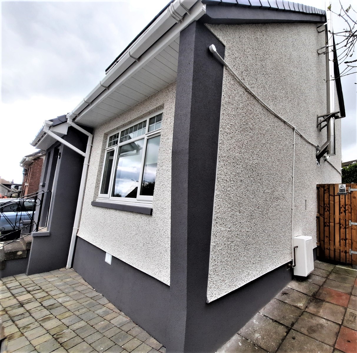 small house corner with fresh roughcast repair