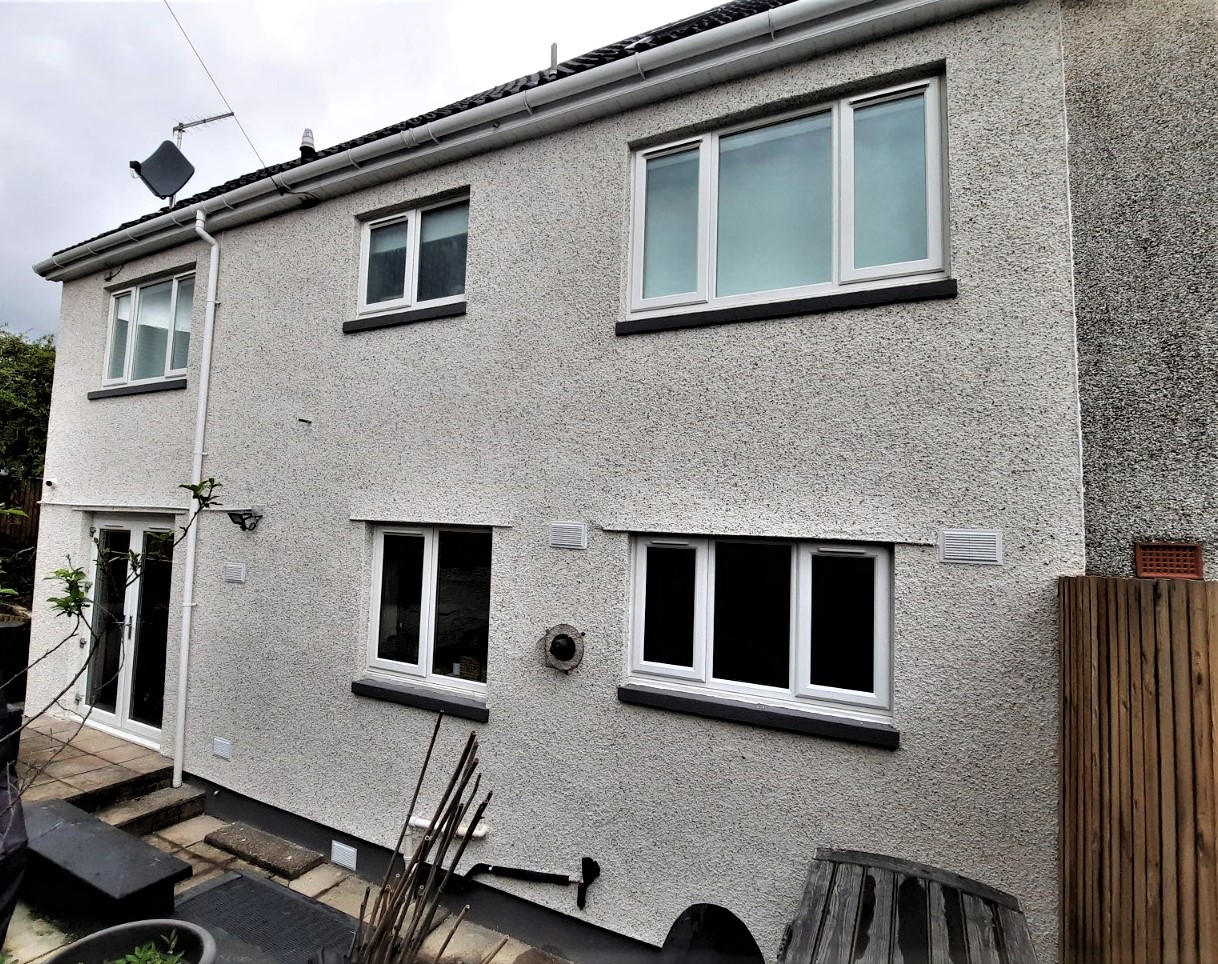 roughcast render repair on upper storey of family home