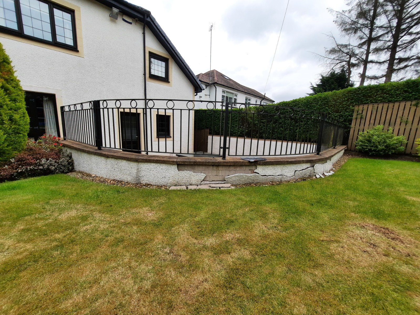 Rendering Edinburgh on exterior wall with black metal railing above