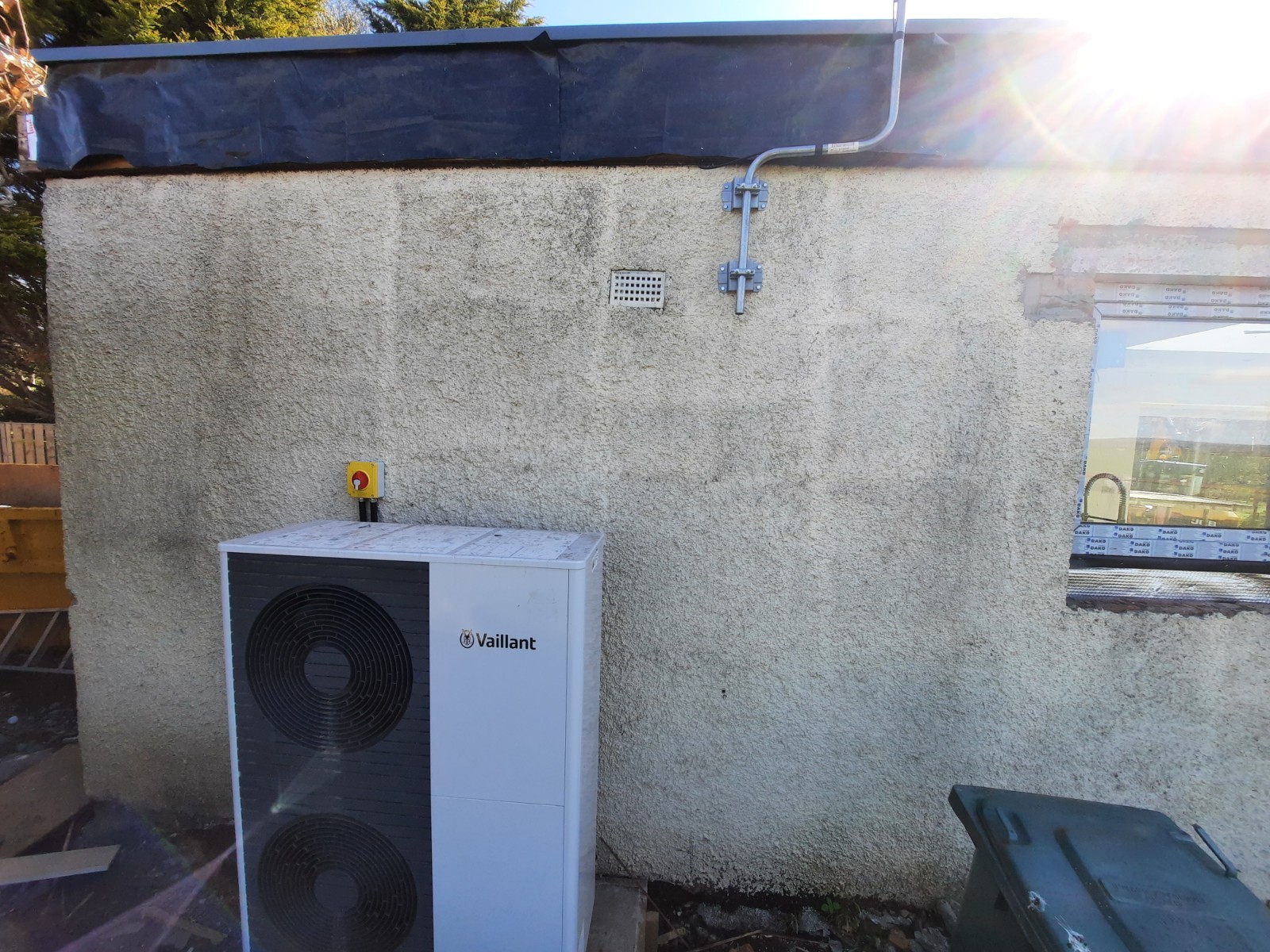 roughcast render Edinburgh beside outdoor heat pump unit