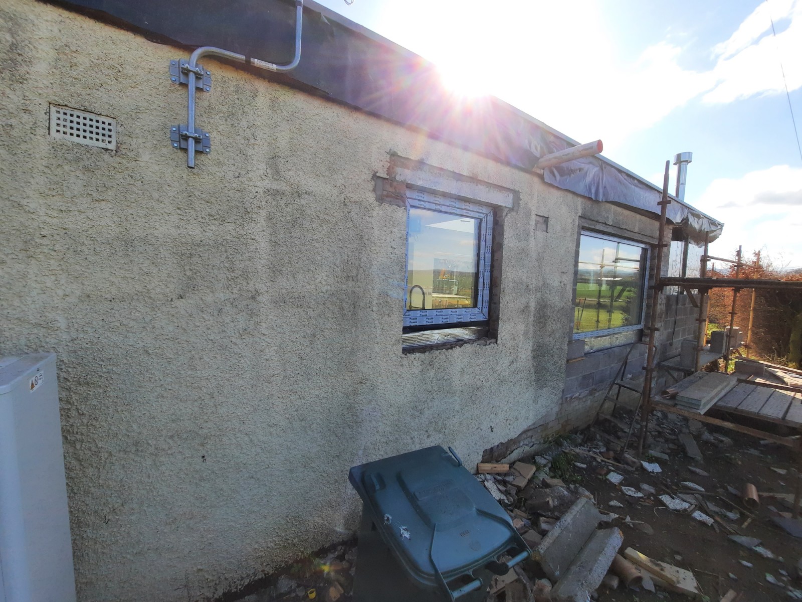 roughcasting Edinburgh on worn exterior wall during renovation